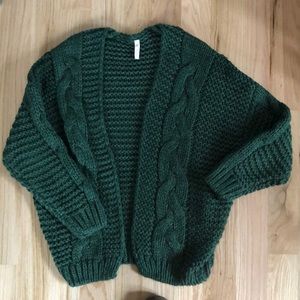 Thick cable knit green sweater.